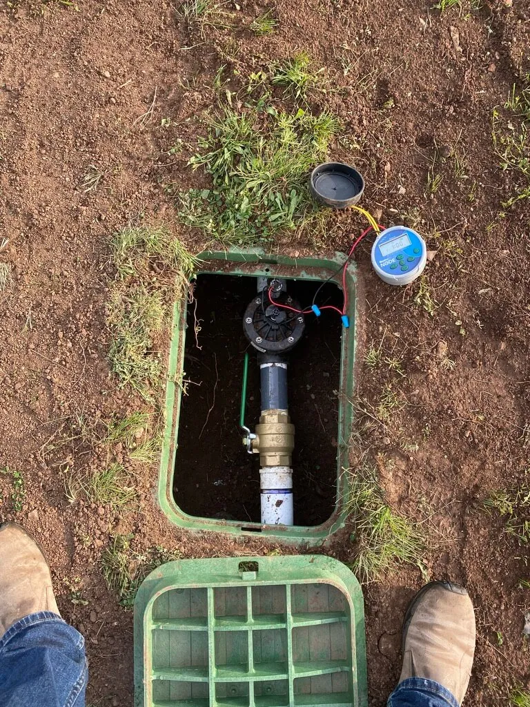 A valve box hidden on the ground